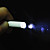  3-in-1 cigarette en forme de lampe de poche à LED blanche + laser rouge + noir de porte-clés stylo à bille (3 * LR41)